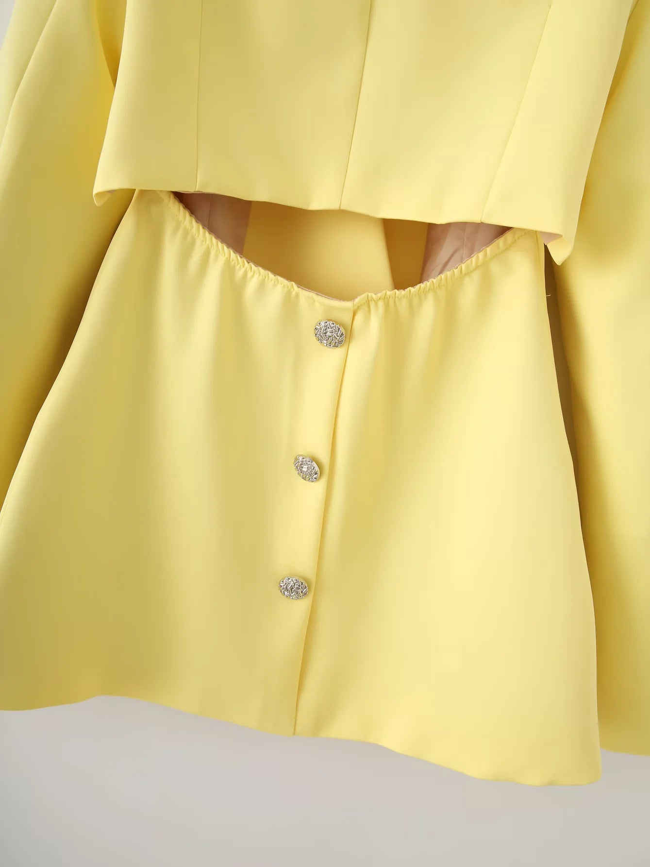 Women's structured blazer with elegant fold-over sleeves and decorative closure NOVAE