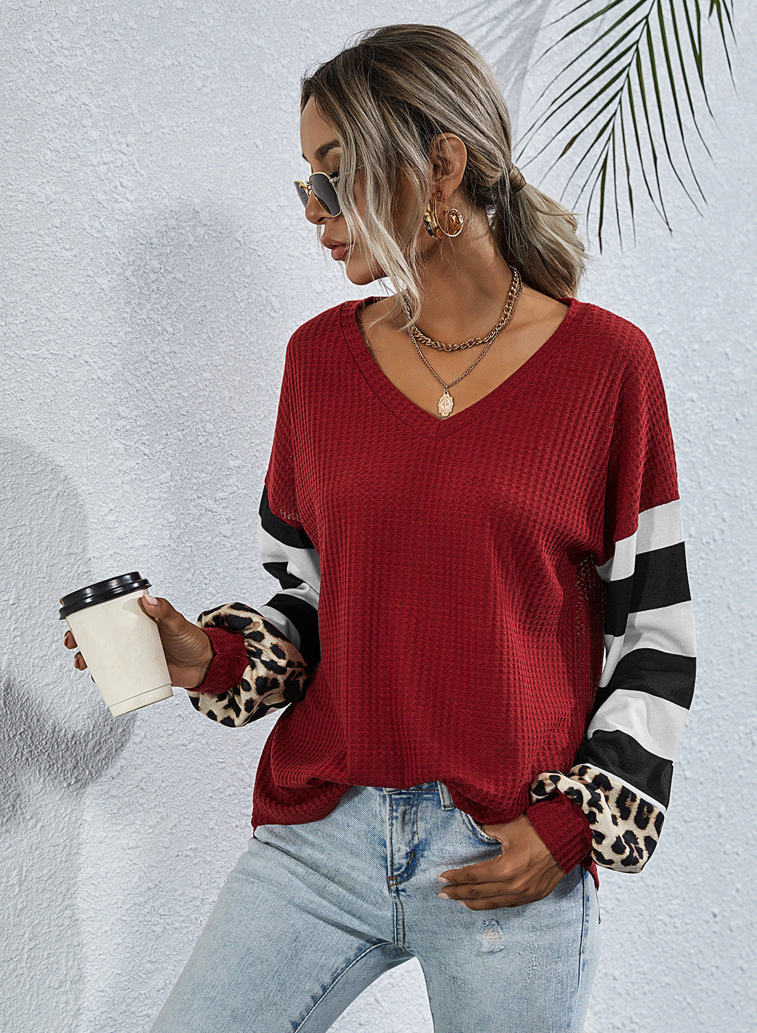 Women's sporty V-neck top with striking sleeves and unique details NOVAE