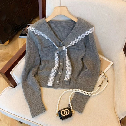 Women's cardigan with ruffled neckband and decorative buttons NOVAE