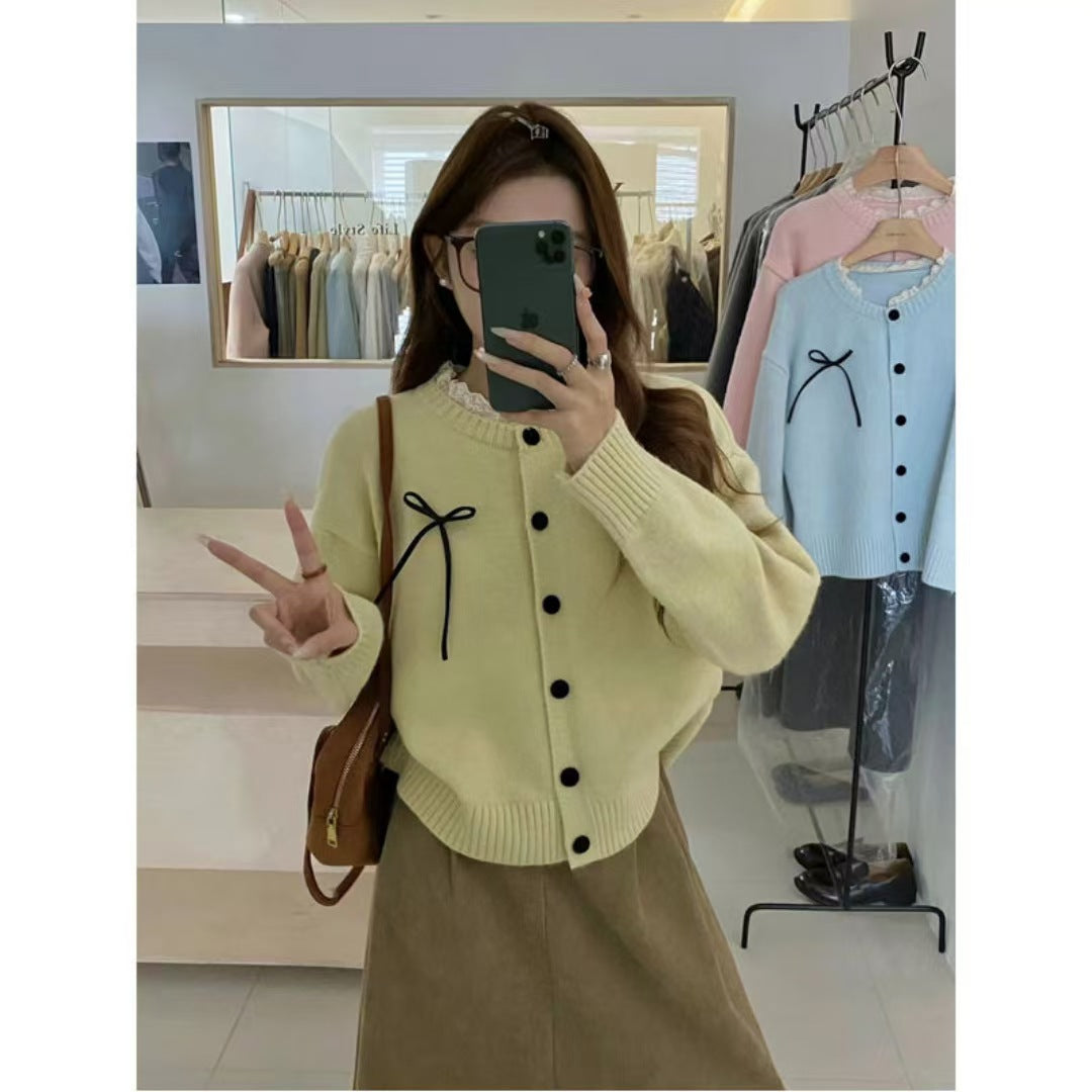 Women's knitted cardigan with decorative buttons and bow accent NOVAE