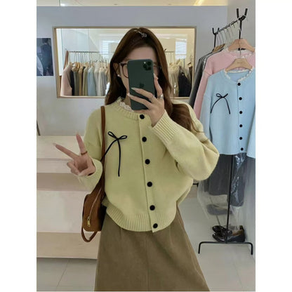 Women's knitted cardigan with decorative buttons and bow accent NOVAE