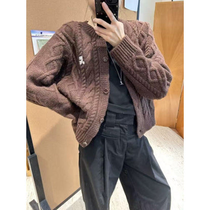 Women's chunky knit cardigan with elegant cable design and unique button details NOVAE