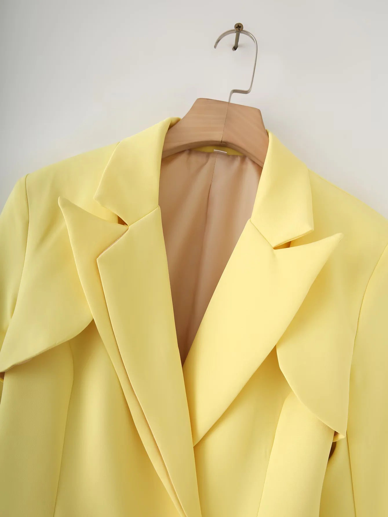 Women's structured blazer with elegant fold-over sleeves and decorative closure NOVAE