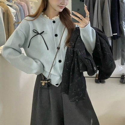 Women's knitted cardigan with decorative buttons and bow accent NOVAE