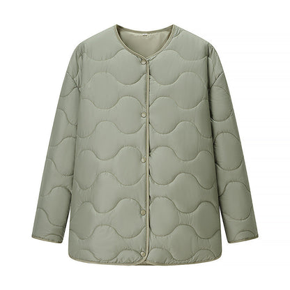 Women's quilted transitional jacket with soft fabric texture and practical snap fasteners NOVAE