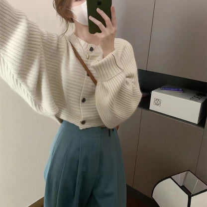 Women's fashionable knitted throw with button detail and structured design NOVAE